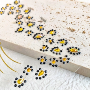 Face gem stickers with gold and black crystal rhinestones for animal pattern makeup looks