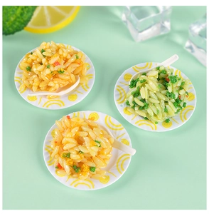 Macro view of miniature egg fried rice models on white plates with tiny spoons