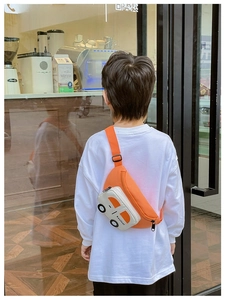 Detail of cartoon car chest bag in orange and beige with adjustable shoulder strap