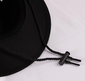 Detail of western cowboy hat featuring adjustable black windproof chin strap and cord lock