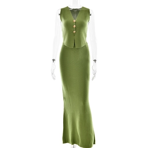 Detailed close-up of green knit vest with gold buttons and matching knit maxi skirt