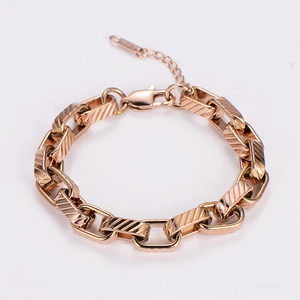 Close-up of rose gold stainless steel thick chain bracelet with diagonal twill texture