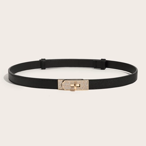 Adjustable skinny black waist belt for dresses featuring a crystal-studded gold turn-lock buckle