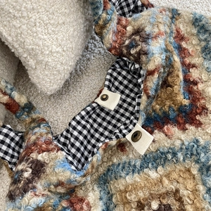 Detail of color-block fleece tote with black gingham lining and vintage metal buttons
