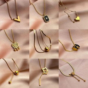 Golden titanium steel necklaces collection featuring clover and butterfly pendants for women