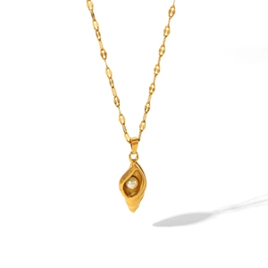 Detail of a gold conch shell pendant featuring a white pearl on a gold link chain
