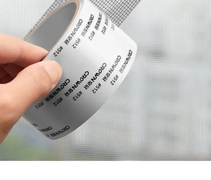 Macro shot of gray mesh window screen repair tape with Crown 512 adhesive backing