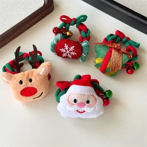 Close-up of plush Christmas hair ties with bells, Santa Claus and reindeer designs