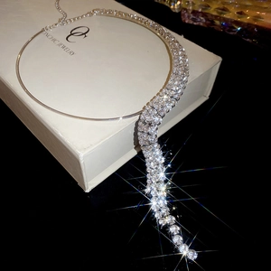 Detailed view of silver fringed choker necklace with sparkling rhinestones on jewelry box