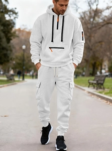 Men's white textured hoodie and cargo jogger set shown in an outdoor lifestyle setting