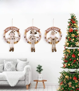 Close-up of three festive Christmas wreaths with plush elk, santa and snowman figures