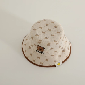 Detailed view of corduroy texture and embroidered bear design on kids bucket hat
