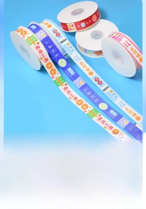 Close-up of printed polyester gift ribbons with colorful blessing texts and patterns