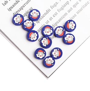 Detail of round Santa Claus polymer clay beads for DIY jewelry making and Christmas crafts