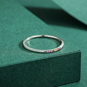 Minimalist S925 sterling silver ring with colorful rainbow gemstones on green pedestal