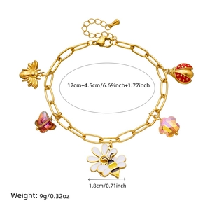 Detailed view of adjustable golden charm bracelet with flower, bee and ladybug pendants