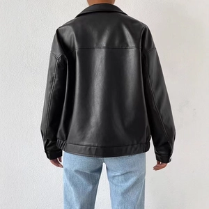 Back view of a black faux leather biker jacket featuring a casual fit and ribbed hem