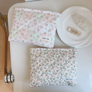 Detail view of pink floral quilted cotton makeup bags with simple wish fabric label