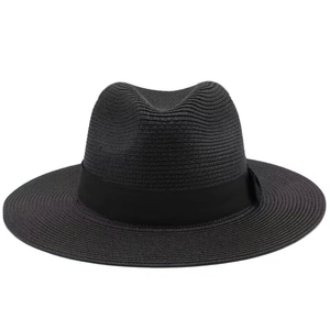Detail view of high-density black woven straw hat with satin ribbon and wide flat brim