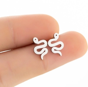 Minimalist silver snake stud earrings in polished stainless steel shown held by hand