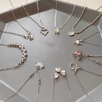 Flat lay of diverse S925 silver necklaces featuring heart and bow pendant charms