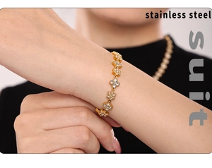 Detail shot of 18k gold plated stainless steel bracelet with zircon flower charm
