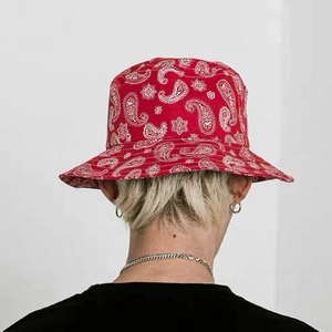 Rear view of model wearing a red paisley pattern bucket hat with classic teardrop motifs