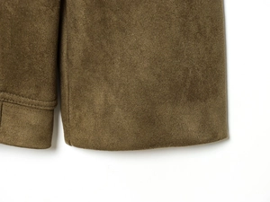 Macro detail of high-quality brown faux suede fabric with precise stitching on hem