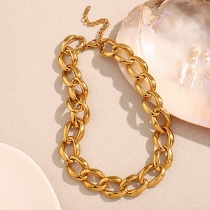 Close-up of chunky gold chain necklace with K18 hallmark tag on minimalist link jewelry