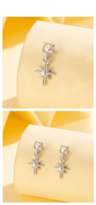 Dettaglio orecchini in argento con zircone colorato e pendente a stella raffinato