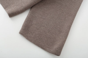Close-up of soft brown knit fabric showing detailed texture and high-quality stitching
