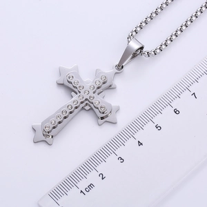 Detailed size measurement of silver double-layered cross pendant with zircons and ruler