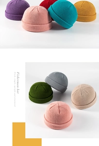 Texture detail of various colorful knit fisherman beanies in soft ribbed wool material