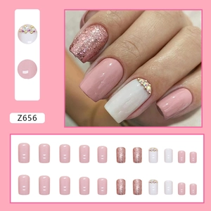 Pink and white square press-on nails with sparkling rhinestones and glitter finish