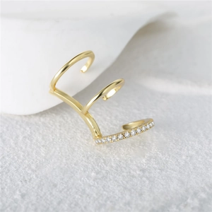 Macro shot of gold layered ear cuff with sparkling marquise crystal detail