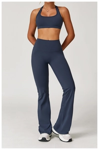 Detail of high-waist navy blue flare yoga pants and backless sports bra set for fitness