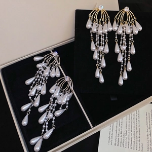 Elegant gold tassel earrings with drop pearls and sparkling zircon in a chandelier style