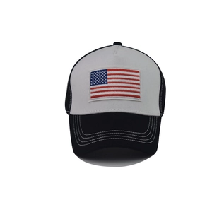 Detail of USA flag embroidery on a black and white mesh trucker hat with quality stitching