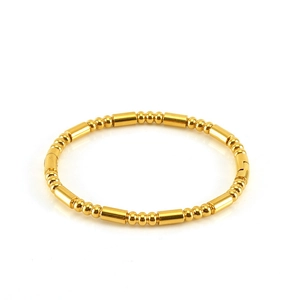 Detailed macro view of 18K gold plated stainless steel bead and bar linked bangle