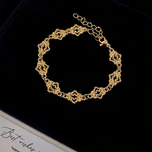Fashionable golden hollow heart chain bracelet with lobster clasp on black velvet