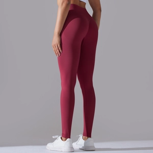 Detail view of burgundy seamless yoga pants with ribbed texture and high waist design
