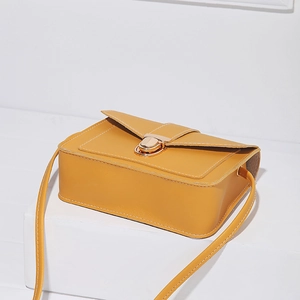 Minimalist yellow PU leather crossbody square bag with golden buckle on white stand