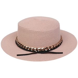 Detail of flat top straw hat featuring a gold chain accent and soft pink woven texture