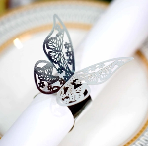 Macro view of laser-cut hollow butterfly napkin ring with shiny silver mirror finish