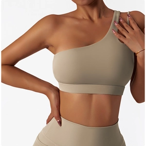 Detail of khaki one-shoulder yoga bra and high-waist leggings with matte elastic fabric