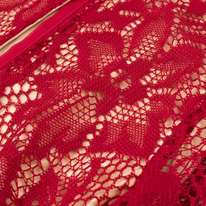 Macro shot of red floral lace fabric with matching invisible zipper and beige lining detail