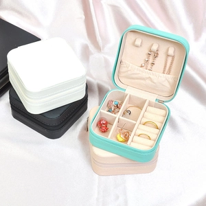 Portable square jewelry organizer boxes in four colors on elegant white silk fabric