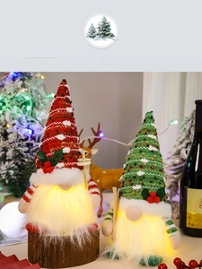 Detail of glowing red and green Christmas gnomes with cozy knit hats and warm LED lights