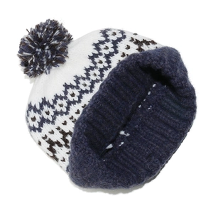 Detailed close-up of Fair Isle knit beanie with geometric patterns and a fluffy pom-pom