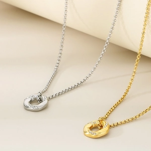 Close-up of 18K gold and silver plated hexagonal pendants with diamonds on O-chains